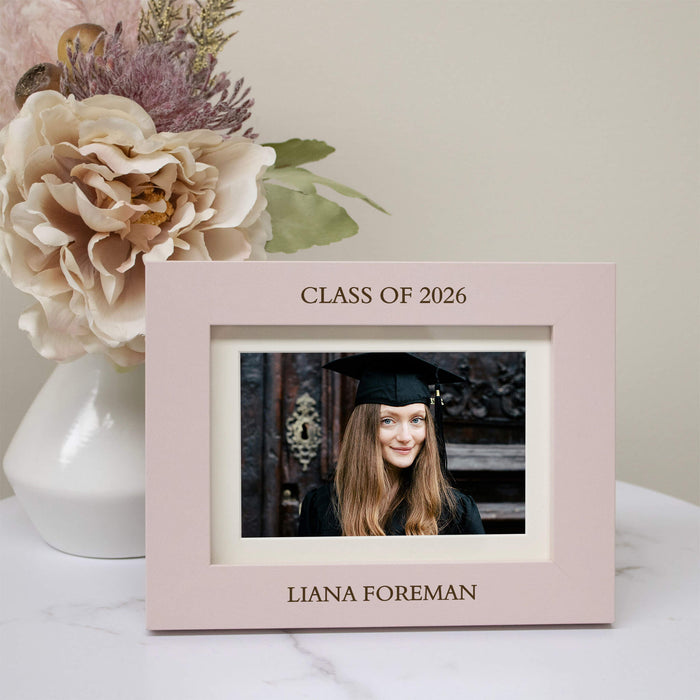Graduation-themed photo frame with a picture of a graduate, flowers, and 'Class of 2026' text.