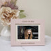 Graduation-themed photo frame with a picture of a graduate, flowers, and 'Class of 2026' text.