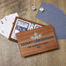 A personalized wooden Christmas card game box printed with 'MERRY CHRISTMAS' THE PETERSON FAMILY 2026 and a snowflake design, shown open with playing cards and dice on a wood surface.