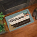 Personalized doormat with 'Welcome to our camp' text on a wooden floor.