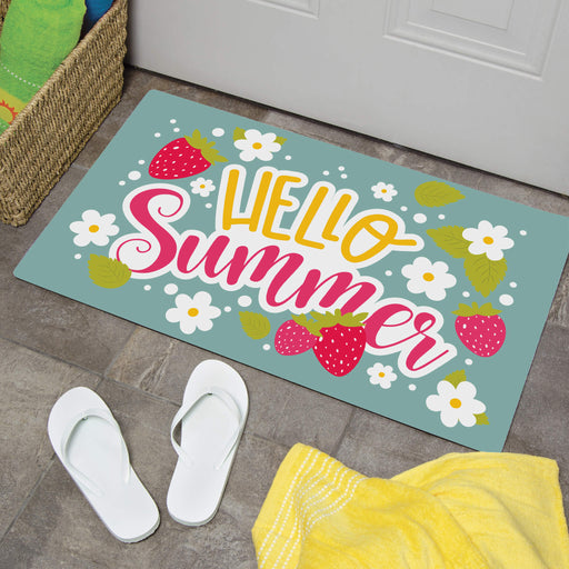 Decorative doormat with 'Hello Summer' text and strawberry design on a floor with white sandals and a yellow towel.