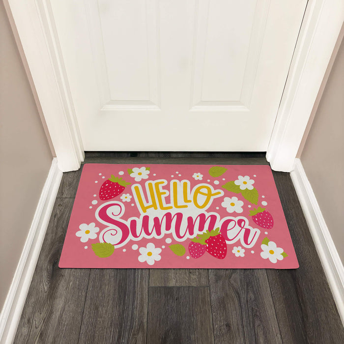 Pink doormat with 'Hello Summer' text and strawberry and flower designs on a wooden floor.