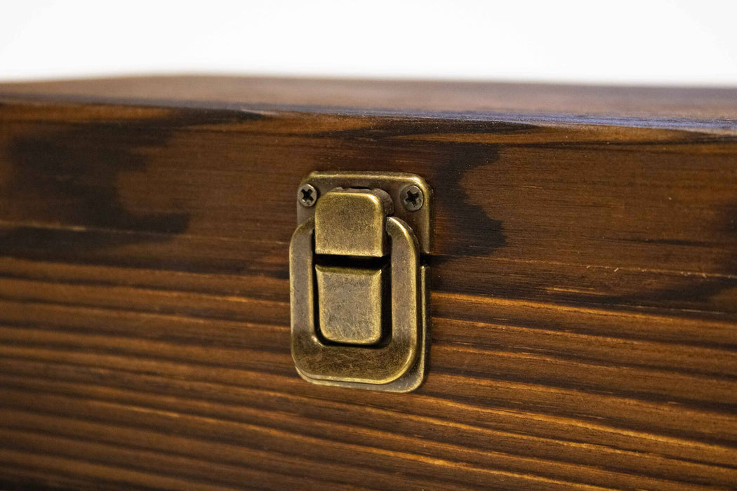 Wooden whiskey smoker set box with a brass latch on a white background