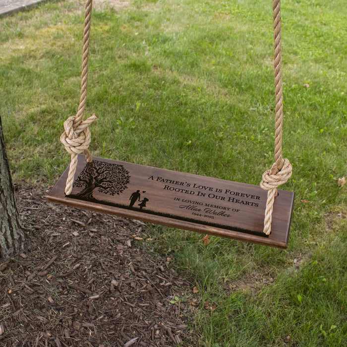 Wooden swing with engraved message in a garden setting