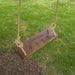 Tree swing hanging in a yard with a personalized design for grandma