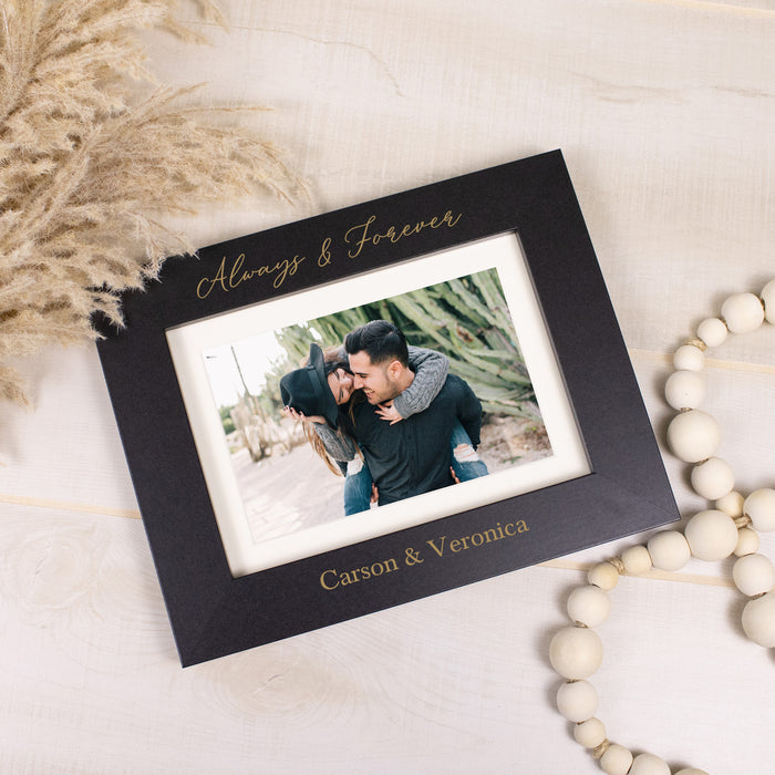 black picture frame engraved with always & forever that can hold a 4x6 or 5x7 photo and is personalized at the bottom with couple's names