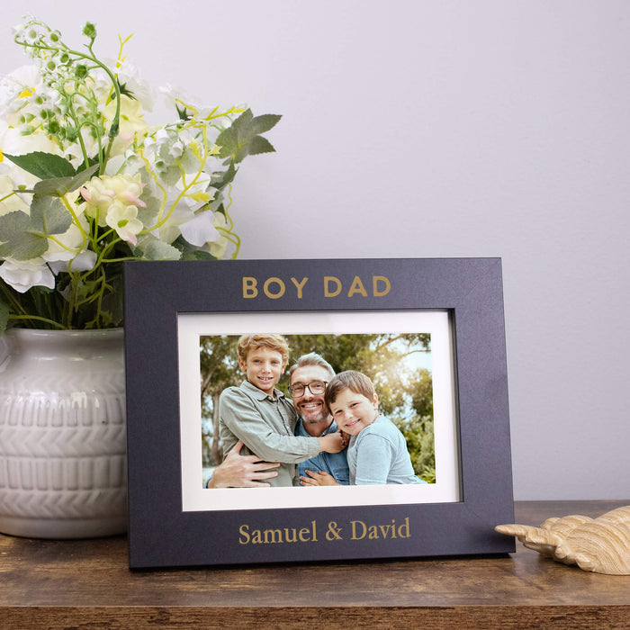 Personalized photo frame with a family picture on a wooden surface with flowers in the background