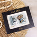 Black photo frame with 'Girl MOM' text, featuring a photo of a woman and a child, on a wicker surface.