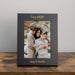 Black photo frame with a family photo and 'Boy MOM' text on a wooden table.