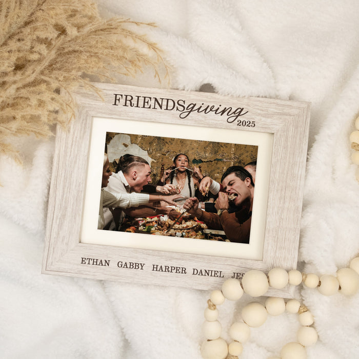 Framed photo of a group of people with 'Friendsgiving 2025' text and names
