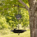 a black bird bath hanging in a tree that has a retirement thank you quote