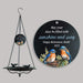 black hanging bird bath with a custom printed sail with a retirement quote