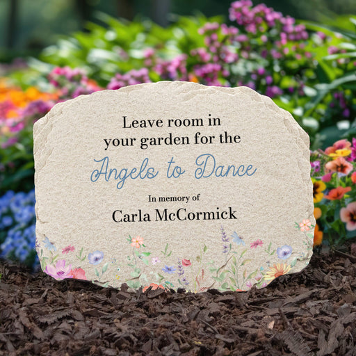 Memorial stone with printed text and floral design in a garden setting