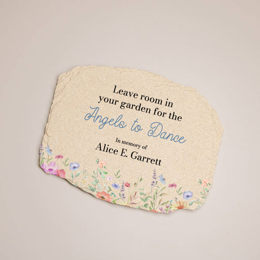 Decorative garden plaque with floral design and text on a beige background
