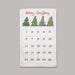 A white Christmas advent calendar with 'Merry Christmas' written in red script at the top, decorated with four green Christmas trees. Below the greeting is a grid of 25 numbered pockets for the days of the week, spanning the 25 days of Christmas.
