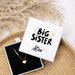 heart shaped necklace with 'Big Sister" and a personalized name printed on the box