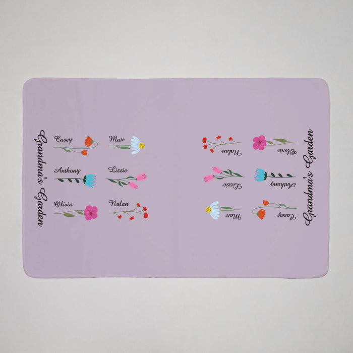 Personalized purple towel with flowers and grandchildren's' names on a gray background