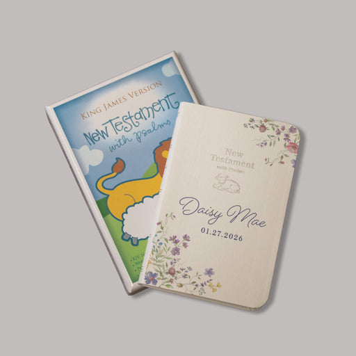 New Testament baby bible with colorful floral cover on a gray background
