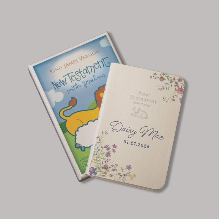 New Testament baby bible with colorful floral cover on a gray background