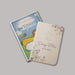 New Testament baby bible with colorful floral cover on a gray background