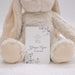 Floral New Testament with personalized name and date, held by a plush bunny toy on a white background