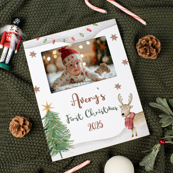 baby's first christmas uv printed picture frame for horizontal picture on a green blanket with pine cones and festive decor