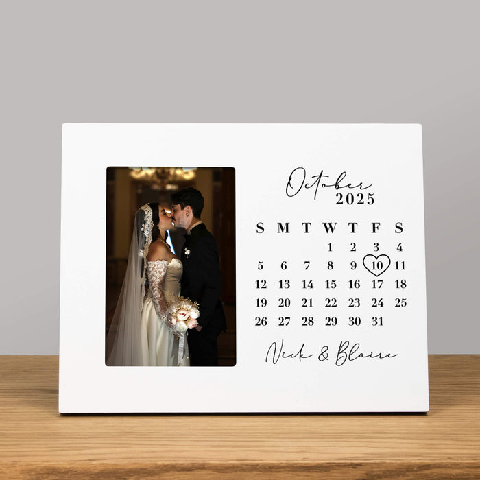 anniversary calendar picture frame with a photo of a bride and groom on a wooden surface