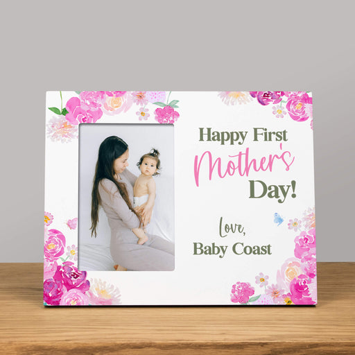 Personalized photo frame with floral design and 'Happy First Mother's Day!' text on a gray background.