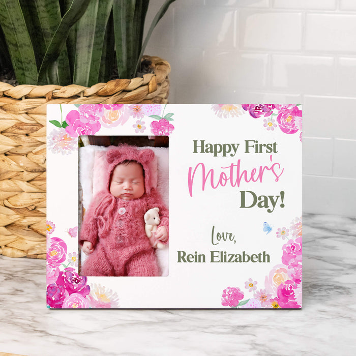 Personalized 'Happy First Mother's Day!' photo frame with a baby photo and floral design on a marble surface.