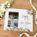 Wedding photo frame with 'Happily Ever After' text and floral design on a wooden surface.