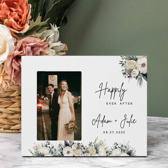 Personalized photo frame with floral design and text, placed on a surface with flowers in the background.