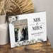 Personalized 'MR & MRS' photo frame with a couple's wedding photo on a wooden surface.