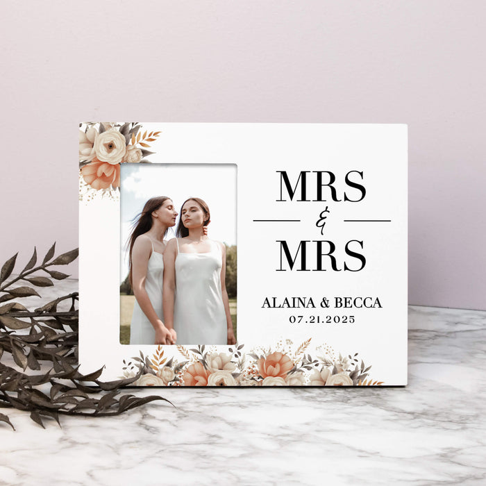 Personalized 'Mrs & Mrs' sign with two women's photo and text on a marble surface.