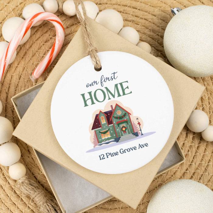 ceramic Christmas ornament made as a housewarming gift sitting on top of a tan gift box