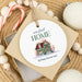 ceramic Christmas ornament made as a housewarming gift sitting on top of a tan gift box