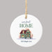 white ceramic circle Christmas ornament printed with 'Our First Home,' a personalized address, and a graphic of a festive home