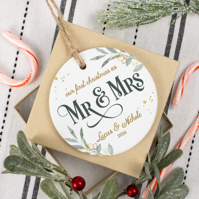 Wedding keepsake ornament shown on top of its gift box surrounded by Christmas decor and candy canes