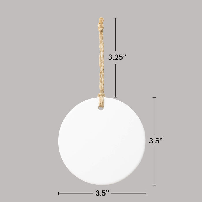 White circular ornament with twine string and measurements on a gray background