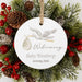 personalized christmas gift ornament with stork and baby announcement text, surrounded by Christmas greenery and berries.