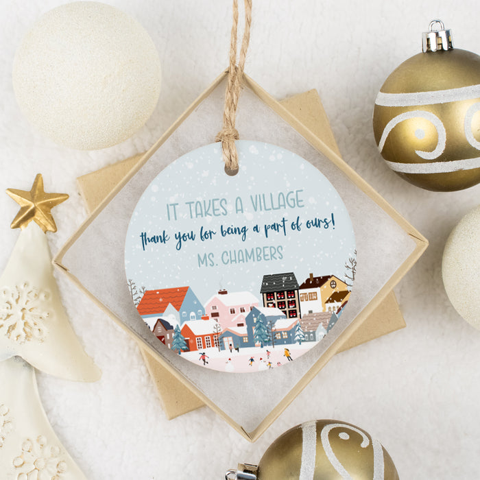 christmas gift ornament for nanny babysitter day care teacher laying in a gift box with white and gold bulbs around the edge