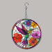 Stained glass acrylic suncatcher with a hummingbird and flowers on a gray background
