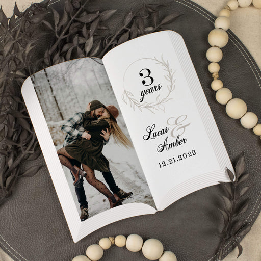 Personalized photo plaque with a couple's photo and text on a decorative surface.
