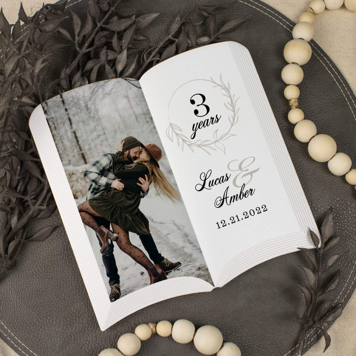 Personalized photo plaque with a couple's photo and text on a decorative surface.