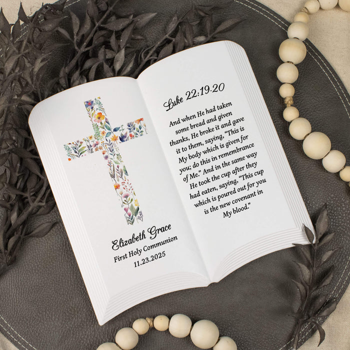 Ceramic open book with personalized text, Luke 22:19-20 bible verse, and floral design on a decorative surface