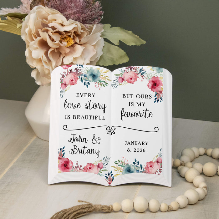 decorative ceramic white book printed with florals and "every love story is beautiful but ours is my favorite"
