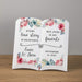 Ceramic open book with floral design and personalized text for a wedding or anniversary on a wooden surface