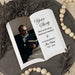 Memorial keepsake with a photo of a man reading a book, text 'Your Story lives on in every heart you touched', and name with years of life on a decorative background.