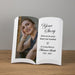 Memorial book with a photo of a woman and personalized text on a wooden surface.