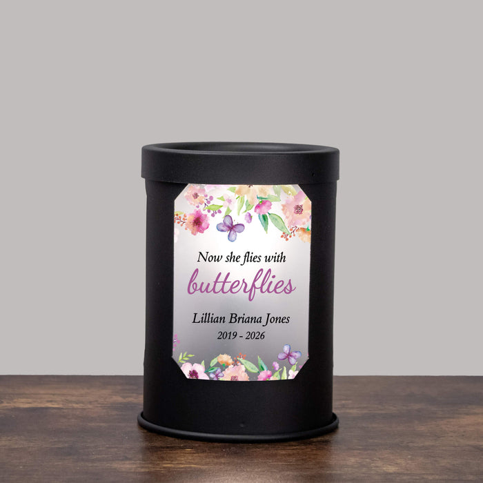 Black wax warmer with a butterfly and floral printed window on a gray background