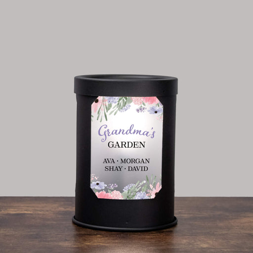 Black wax warmer printed with "Grandma's Garden" and a floral design on a gray background